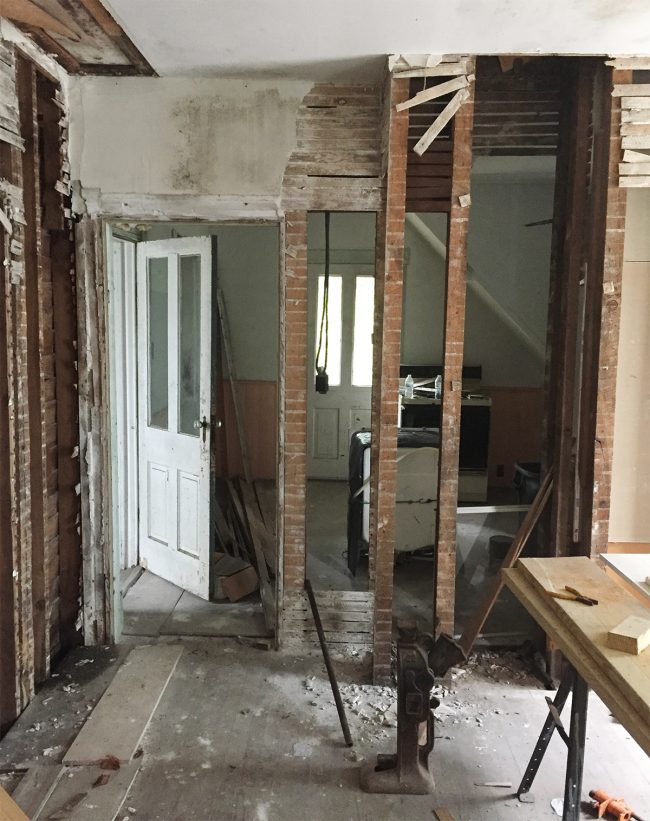 Before Angle Of Beach House Kitchen Looking Towards Back Door With Crumbling Walls