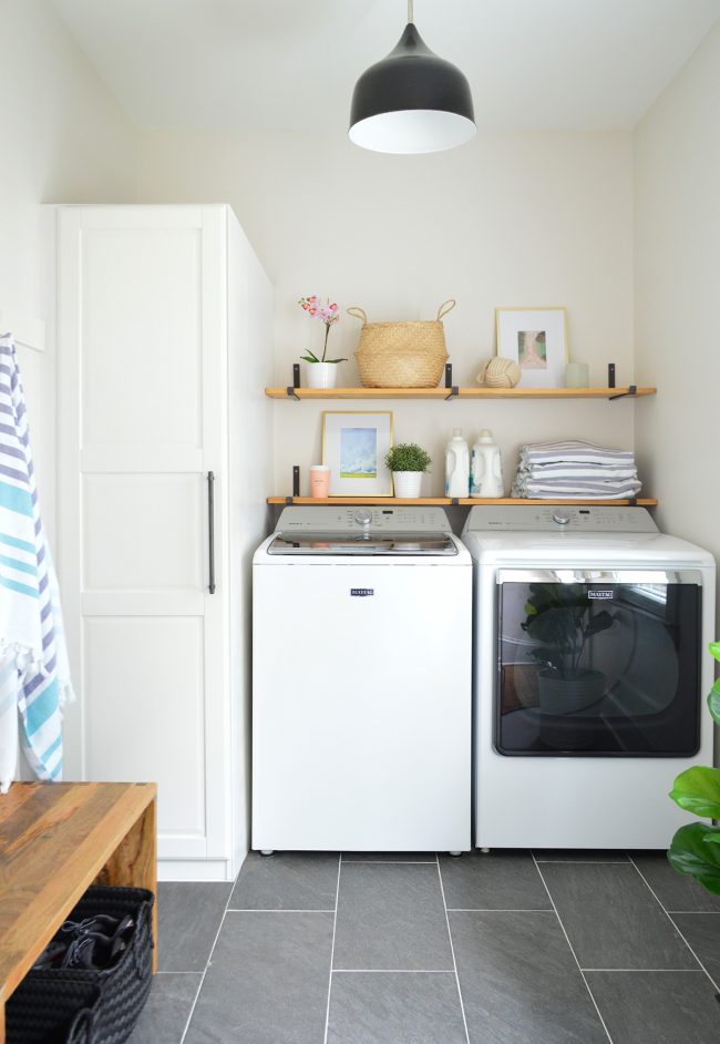 After Photo Of Beach House Laundry Room With Side-By-Side Appliances And Floating Shelves