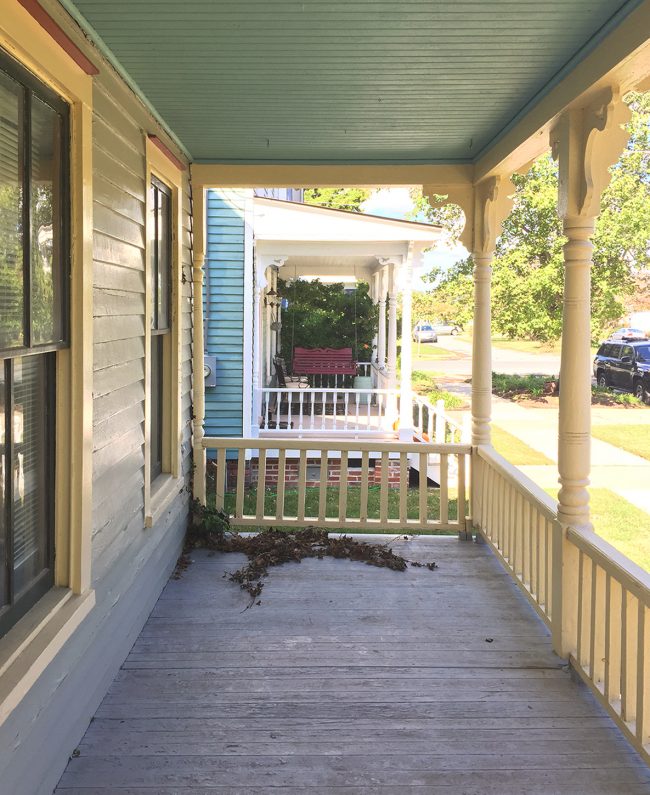 Before Photo Of Beach House Porch With Yellow Trim And Overgrown Porch Weeds