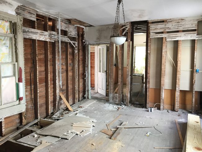 Before Photo of Beach House Kitchen With Exposed Plaster And Crumbling Walls