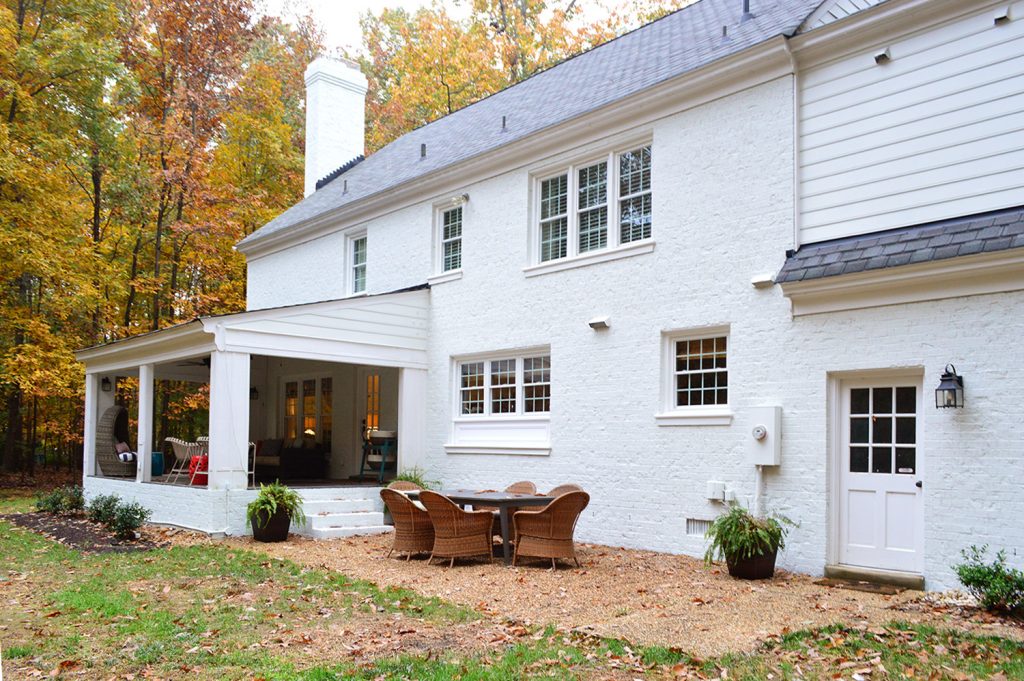 House Painted brick from the back showing two exterior doors white before paint