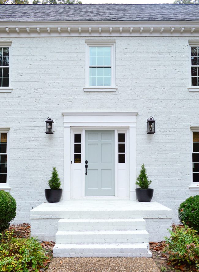 after of brick house front porch with new trim and painted front door