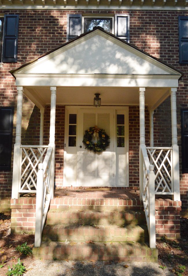 before of front porch of brick house with portico and railings