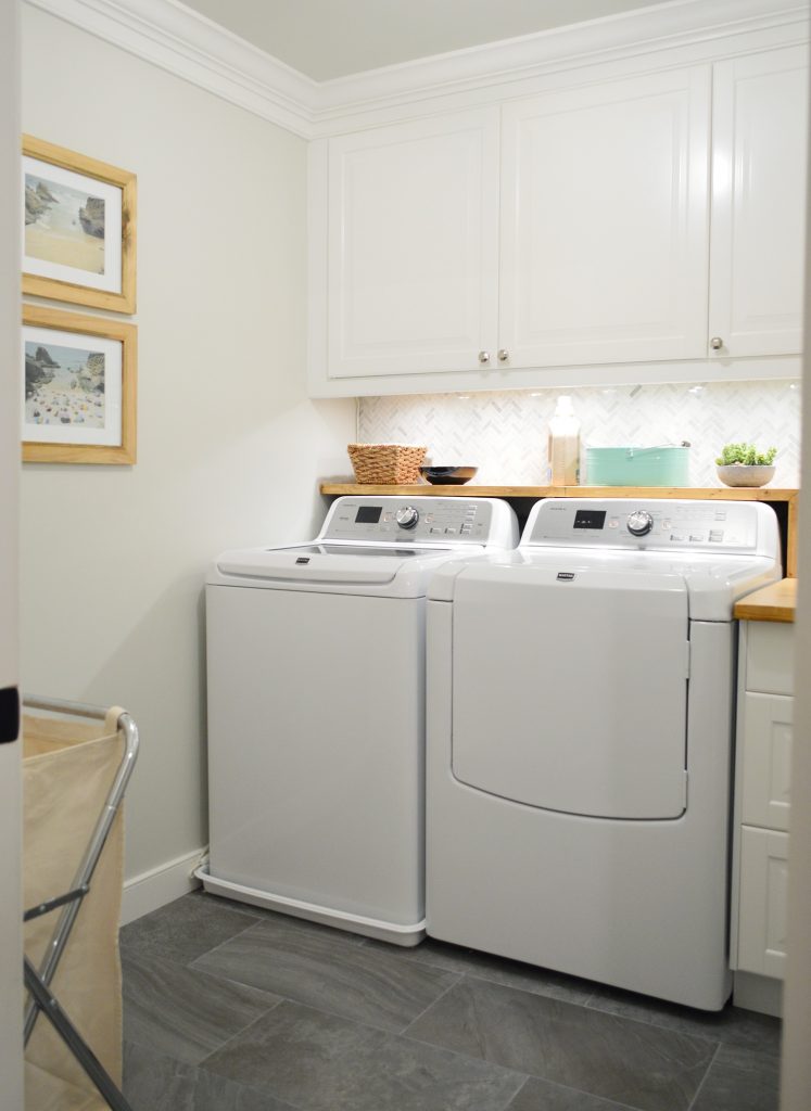 White Laundry Room With Marble Tile Backsplash