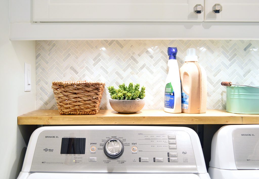 Laundry room shelf with faux succulent in cement pot