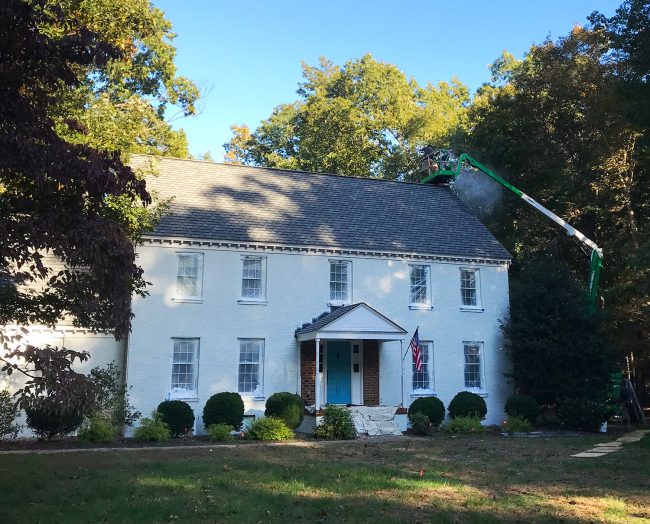 brick house during painting with portico still on