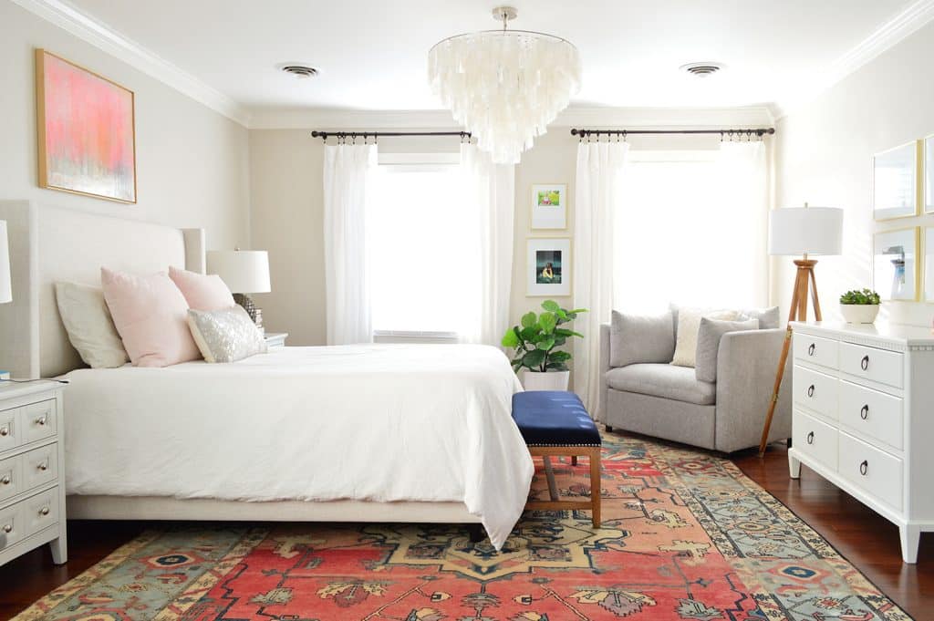 Neutral bedroom with capiz chandelier and faux fiddle leaf fig by window