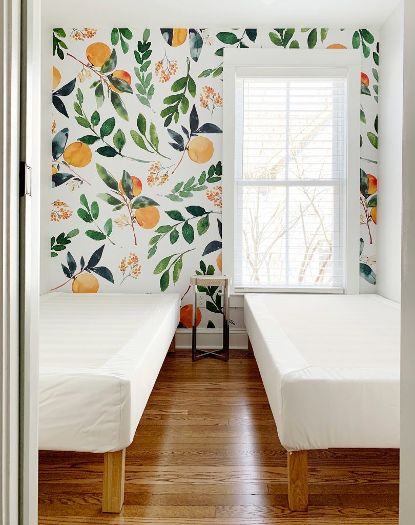 Peel-And-Stick Wall Mural With Oranges In Room With Two Twin Beds