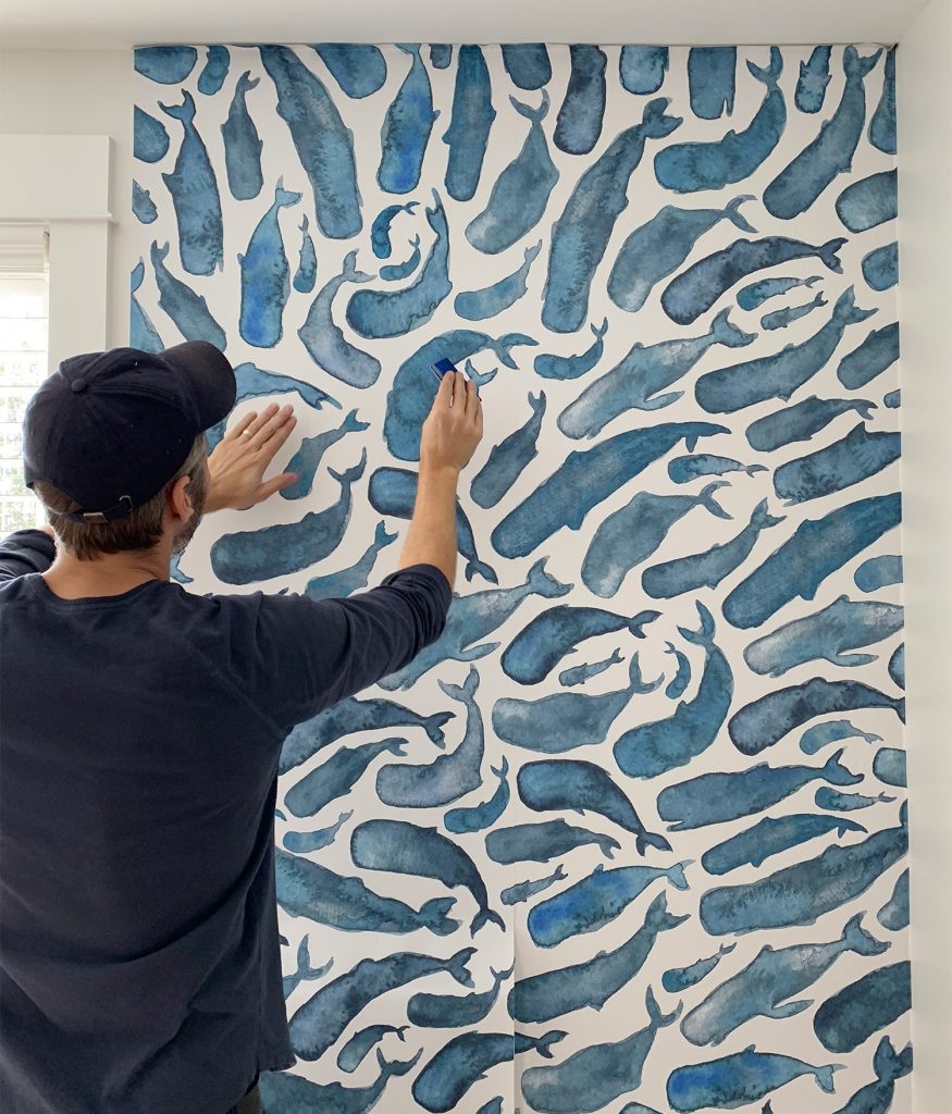 Installing Second Panel Of Removable Whale Wallpaper By Smoothing Creases