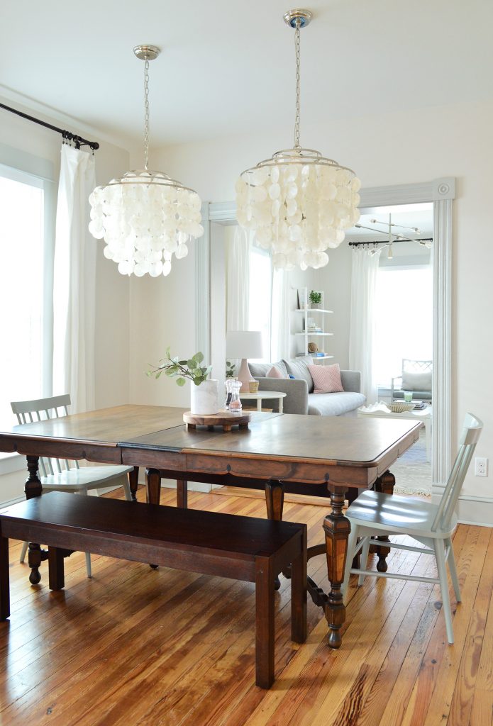 vintage dining table with two capiz chandeliers over top