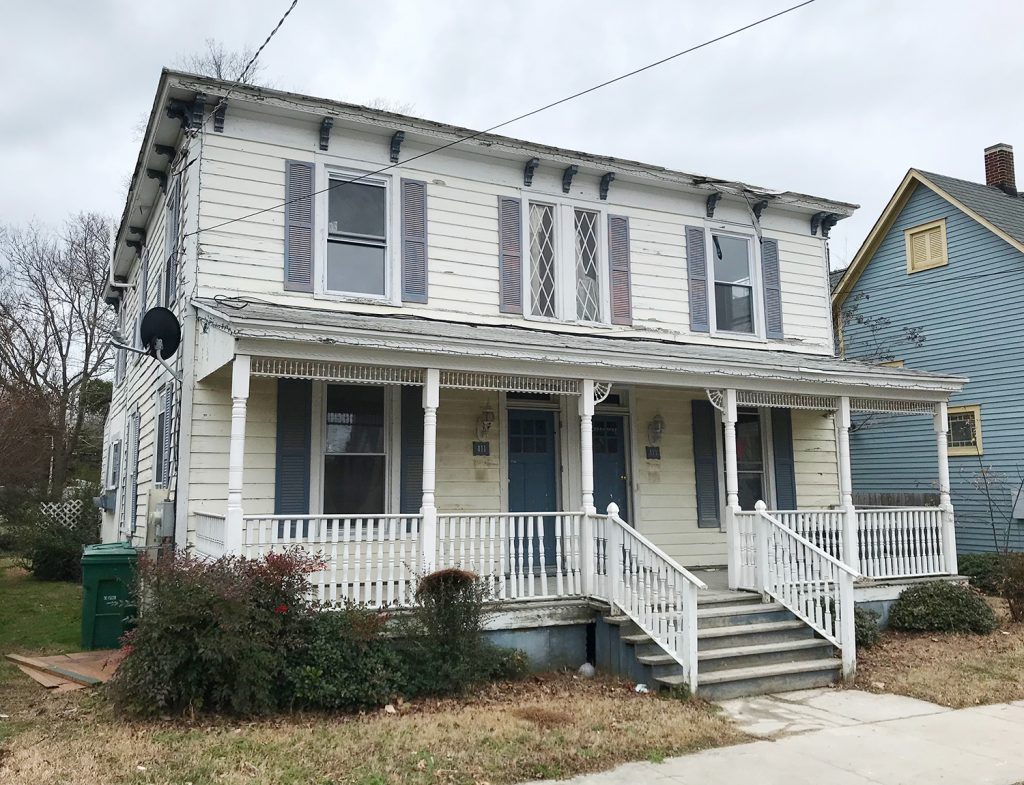 Before Renovation Photo Of Duplex With Crumbling Siding And Windows