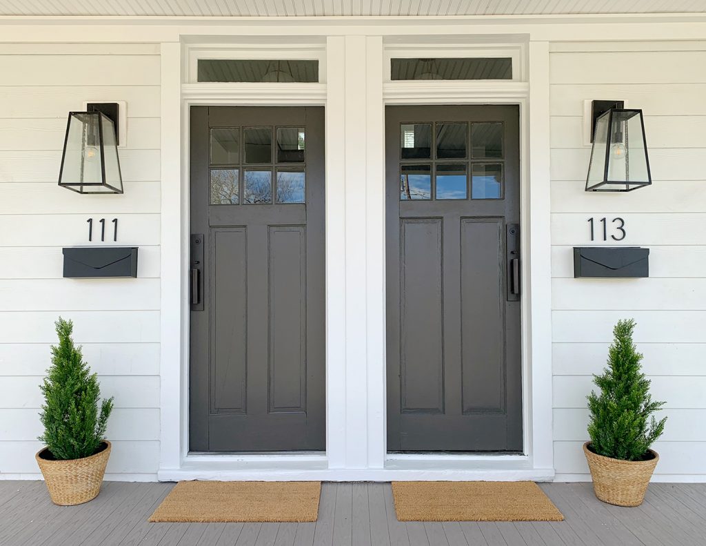 Duplex Front Porch With Matching Dark Gray Doors Plants House Numbers Mailboxes