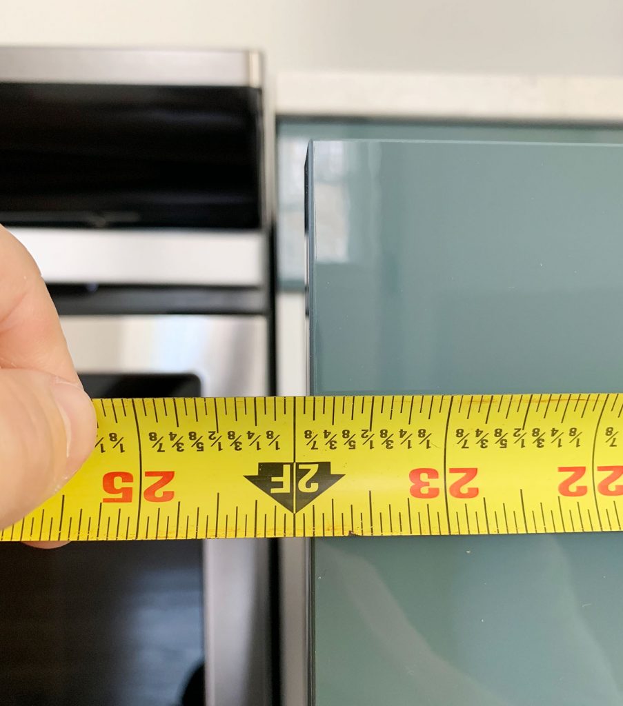 Measured Length Of Cabinet Drawer Front Using Tape Measure