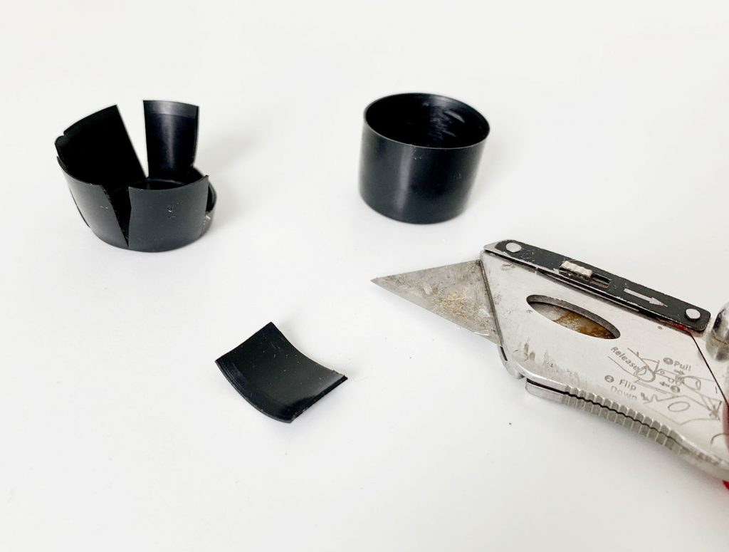 Cut pieces of black plastic to help make curtain rod more level
