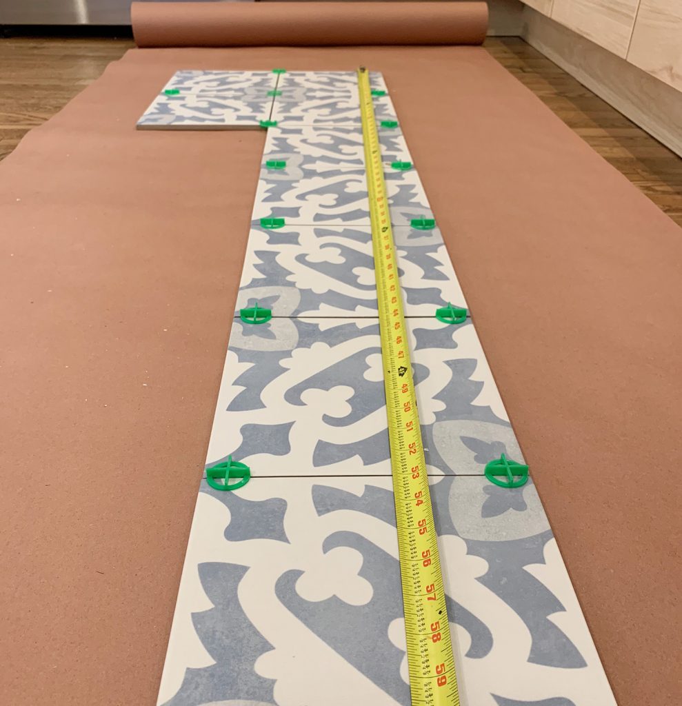 Measuring Tape On Patterned Backsplash Tile To Find Length