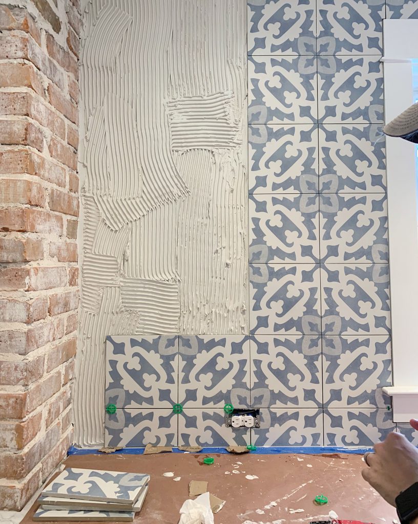 Detalhe do progresso da instalação do backsplash com azulejo de padrão azul