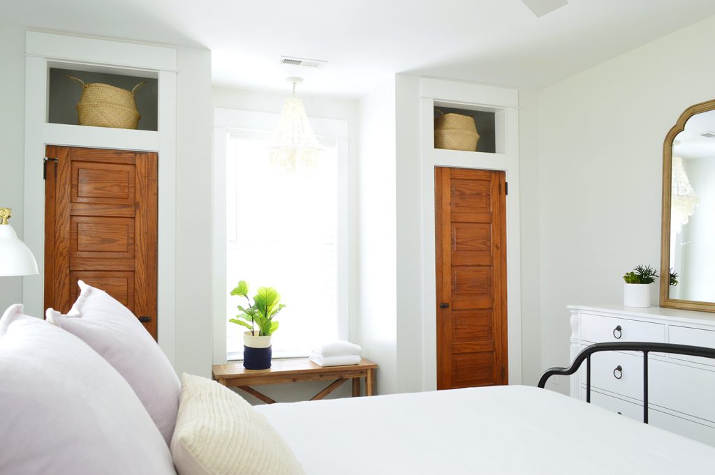 Matching Closets With Reclaimed Wood Doors In Historic Beachy White Bedroom
