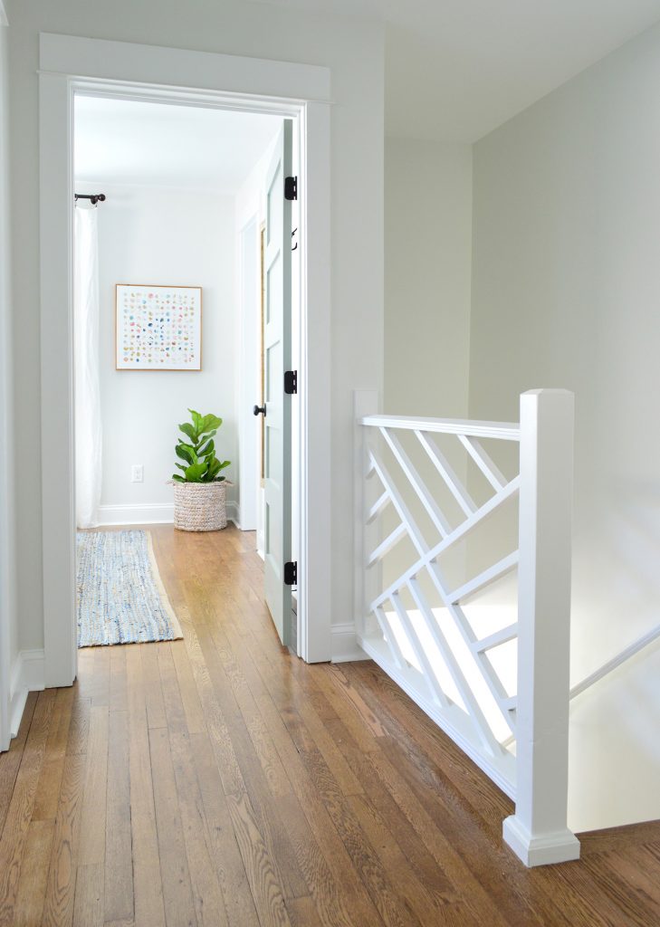 After Photo Of Upstairs Hallway With White Chippendale Railing