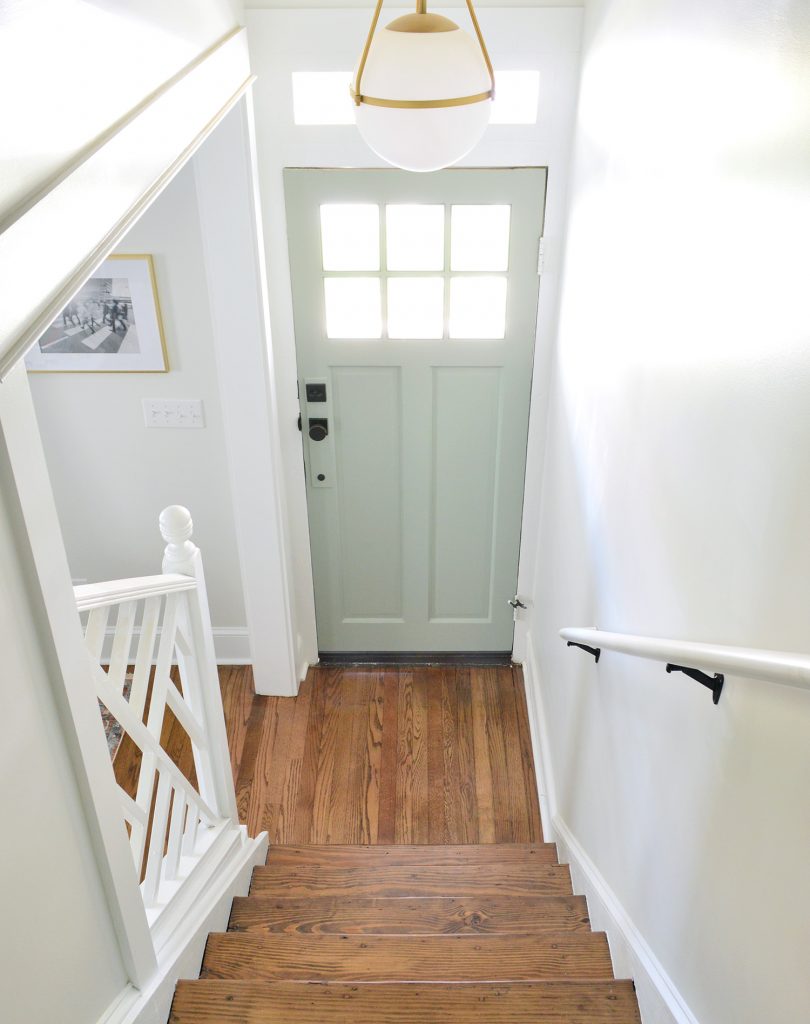 After Photo Looking From Stairs With Colorful Oyster Bay Door And Open Railing