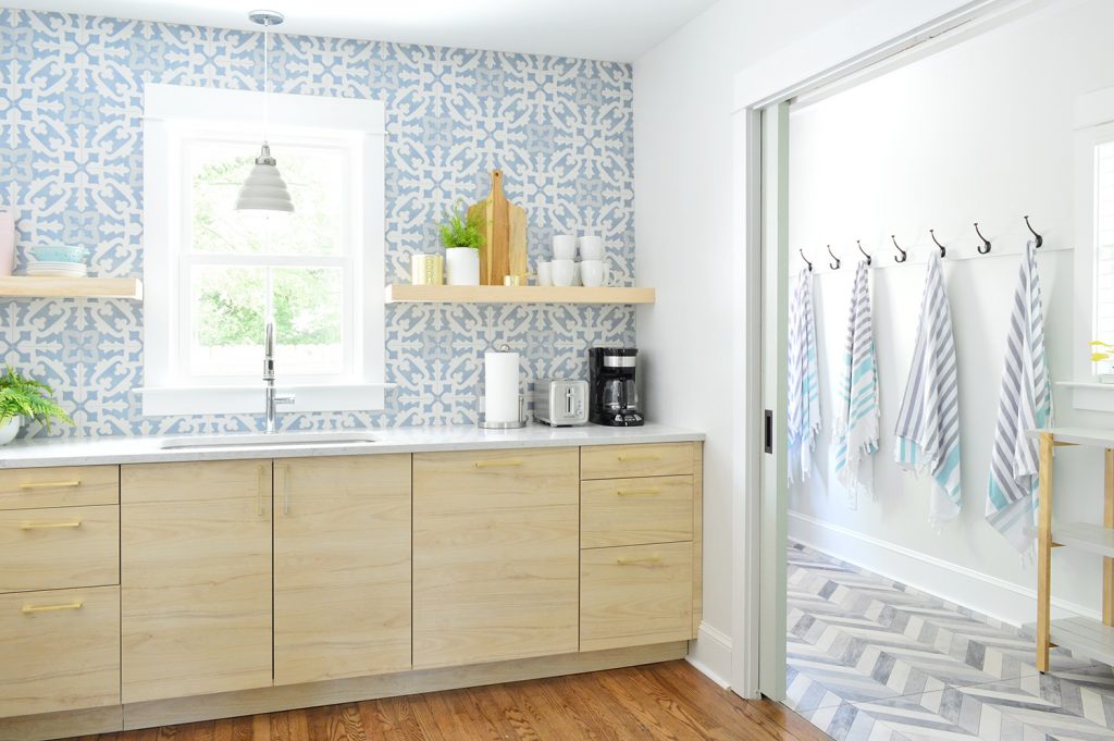 Duplex Mudroom Seen Through Open Pocket Doors With Hangin Towels