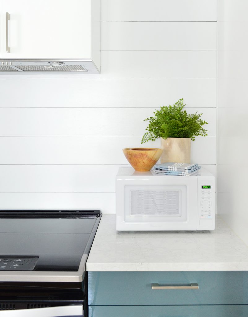 Shiplap Planking Detail In Duplex Kitchen With Blue Cabinets