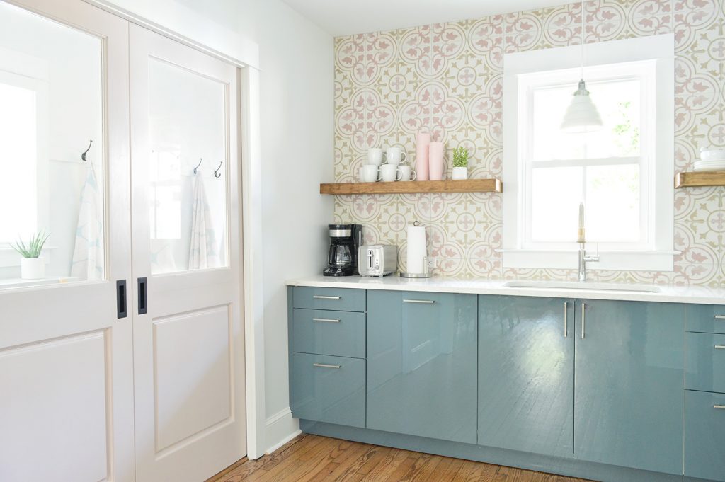 Floating Kitchen Shelves In Colorful Kitchen With Pink Tile And Blue Cabinets