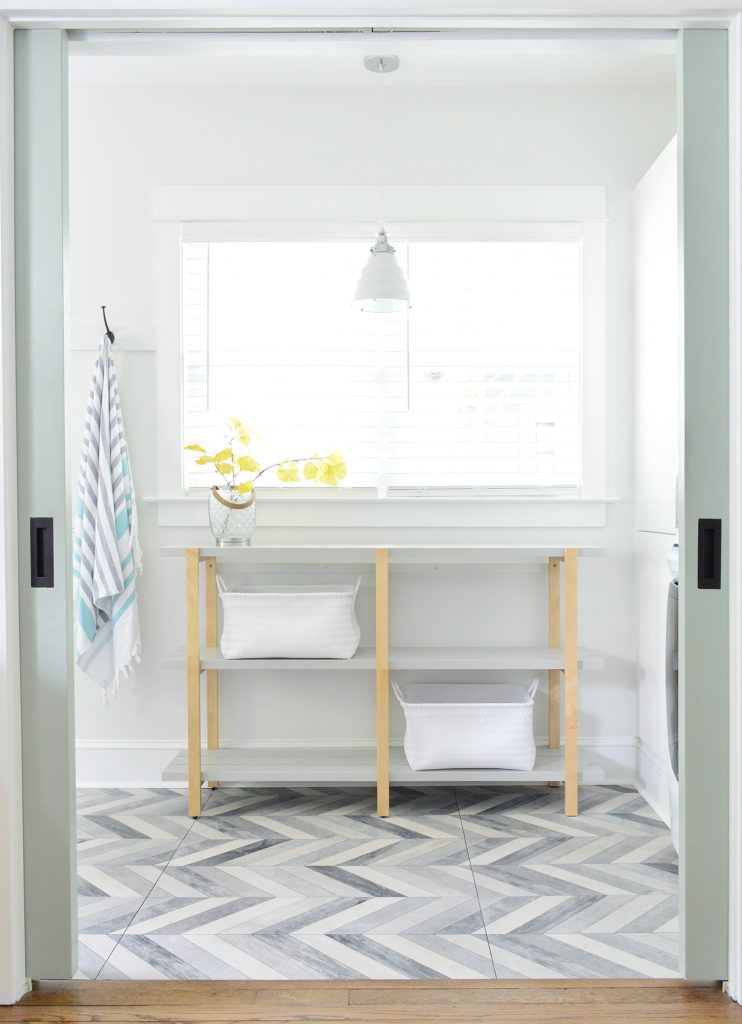 Open Shelf Through Pocket Doors In Duplex Mudroom Laundry