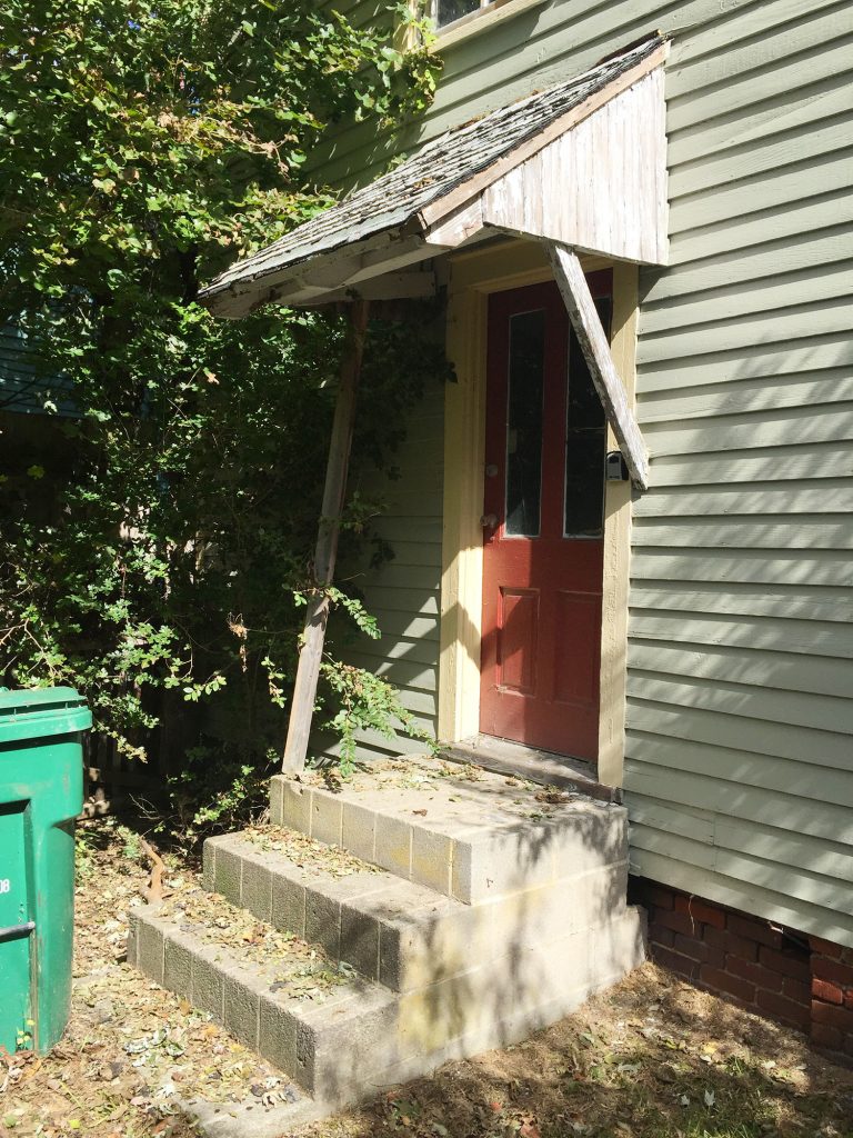 Before Photo Of Beach House Back Door With Falling Wood Awning