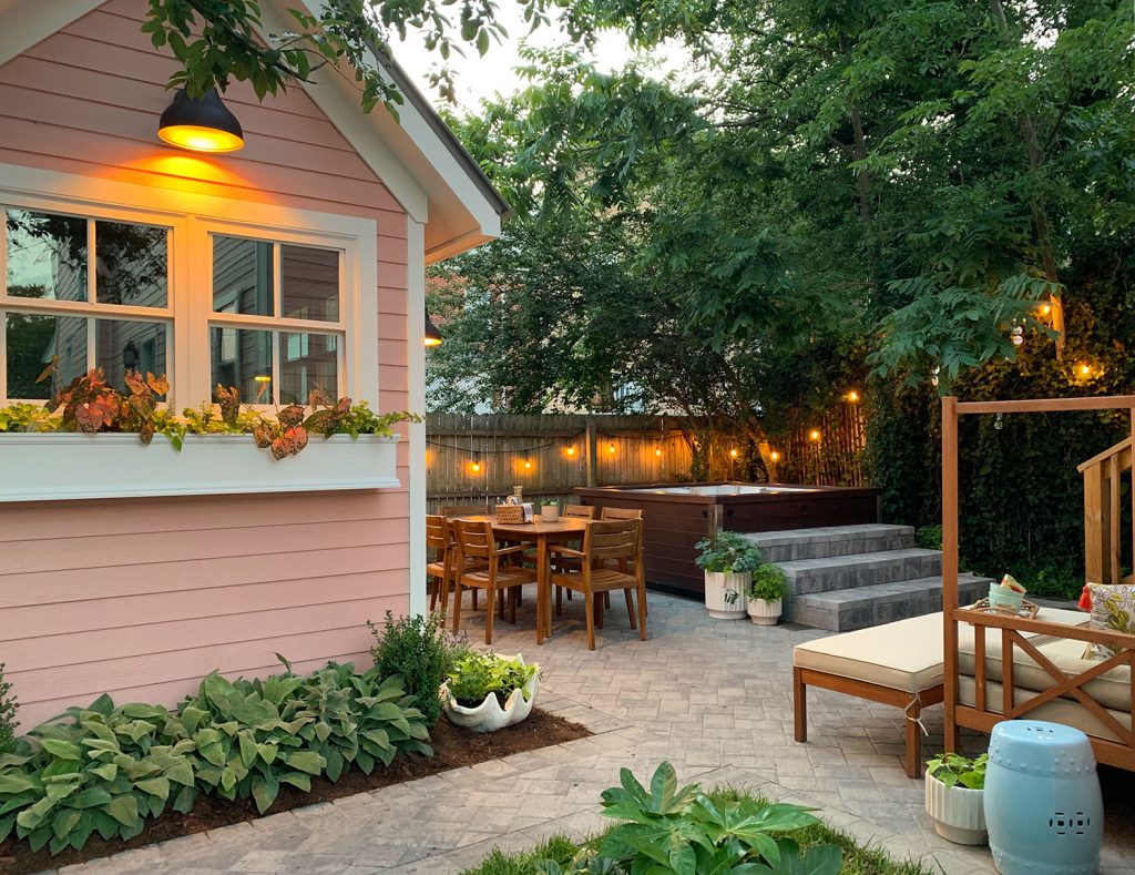 Beach house backyard with paver patio and pink shed