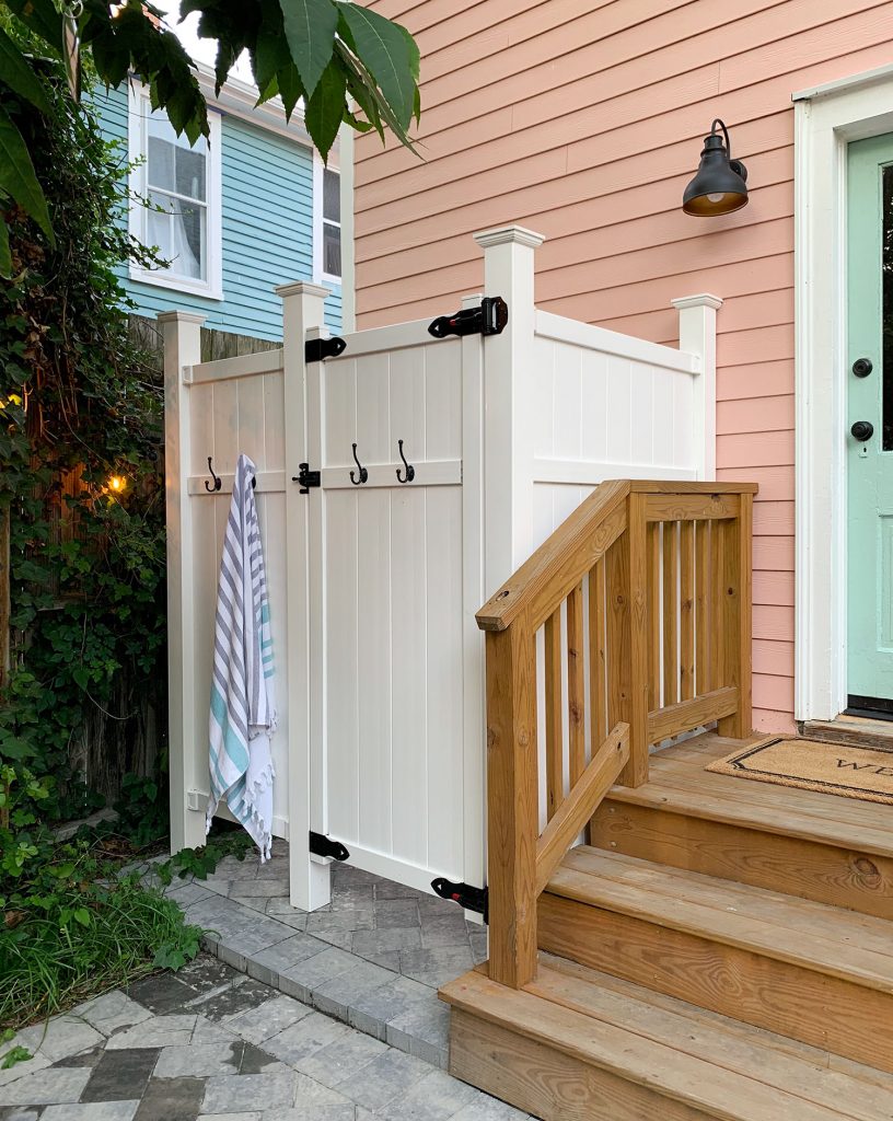 White Vinyl Outdoor Shower Enclosure In Beach House Backyard