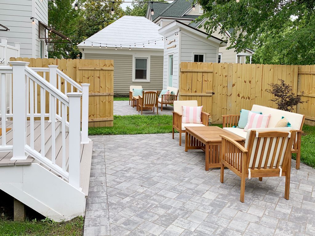 After Of Two Backyard Areas In Duplex With Separate Patios and Wood Privacy Fence