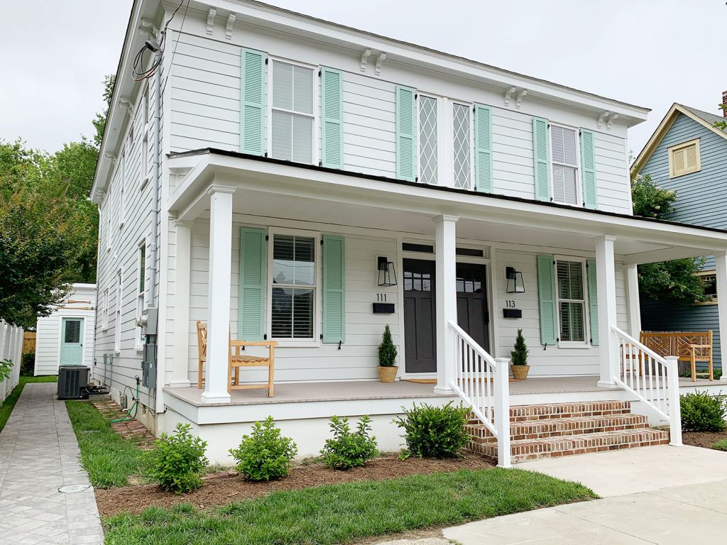 Final Renovation Duplex With New White Siding Windows Brick Stairs Mint Pale Patina Shutters And Wide Porch