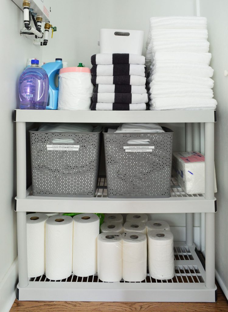 Duplex Owners Closet With Plastic Shelving Labeled Bins