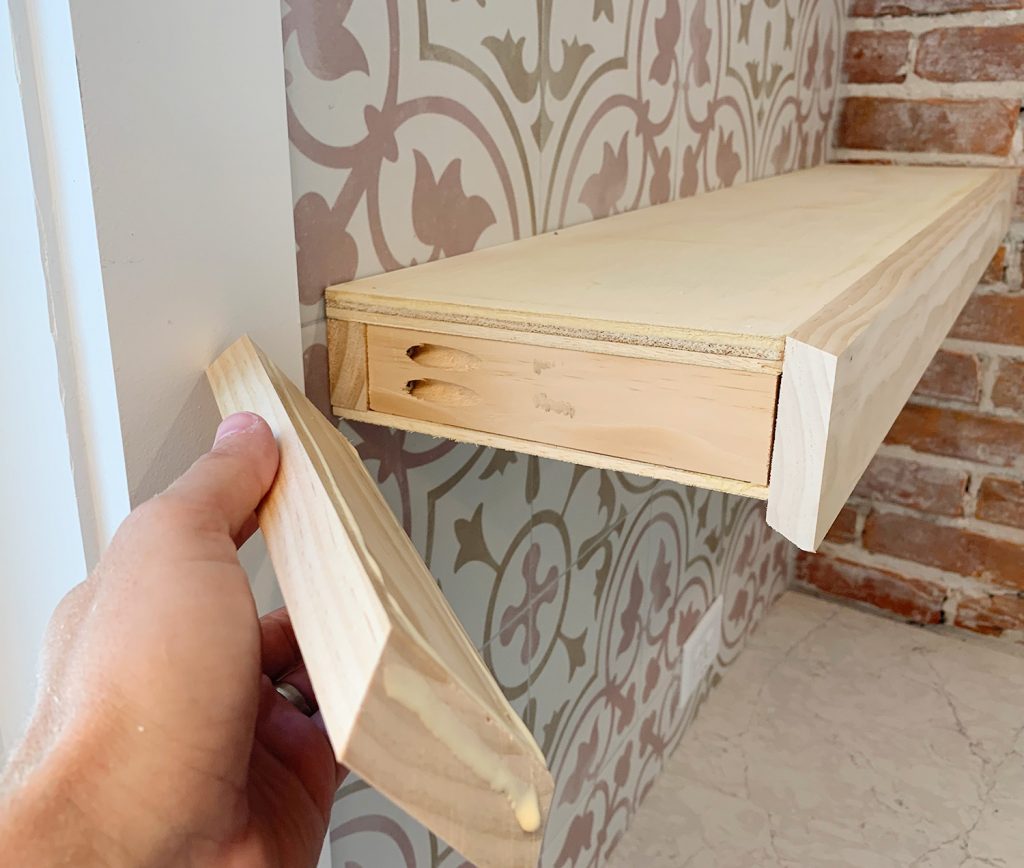 Hand Adding Side Trim Piece To DIY Floating Kitchen Shelves