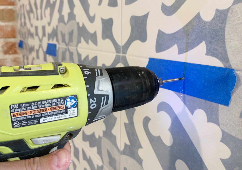 Drilling Through Tile Backsplash Using Marked Spot With Painters Tpae