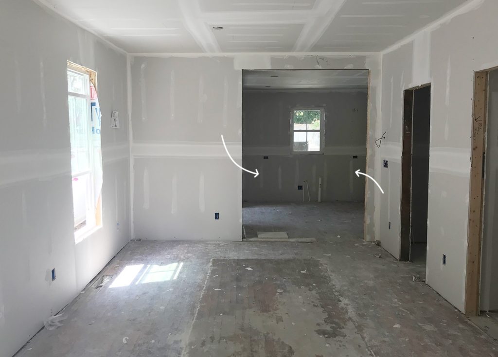 Unfinished Drywall In Duplex Renovation With Kitchen In Background