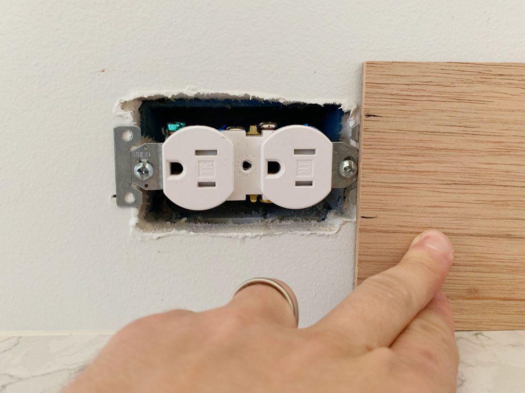 Height Of Electrical Outlet Marked Using Scrap Wood Panel