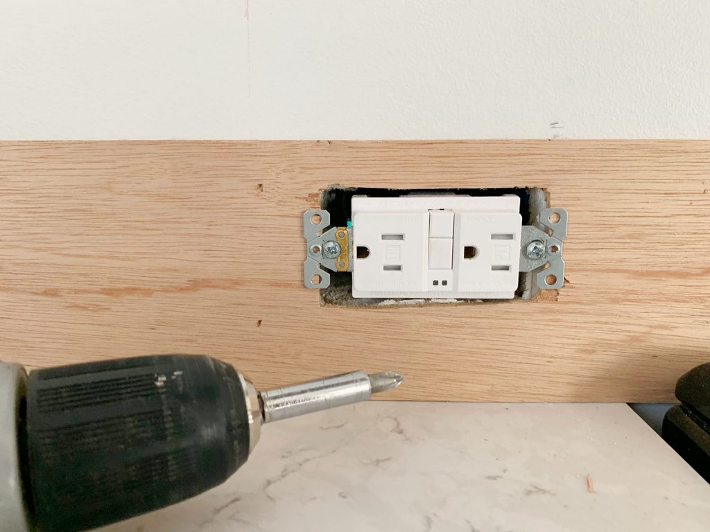 Electrical Outlet Screwed Back In Place Over Panel Strip
