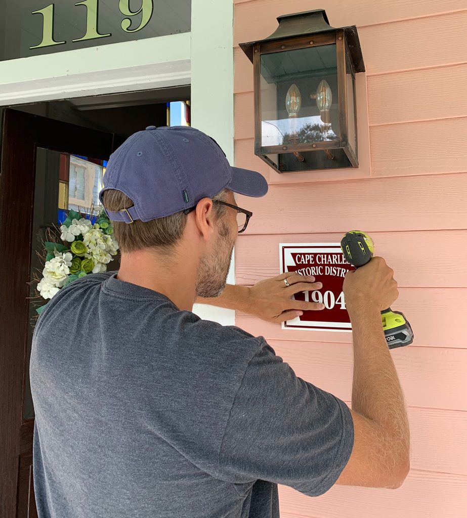 Beach House History John Installing Plaque