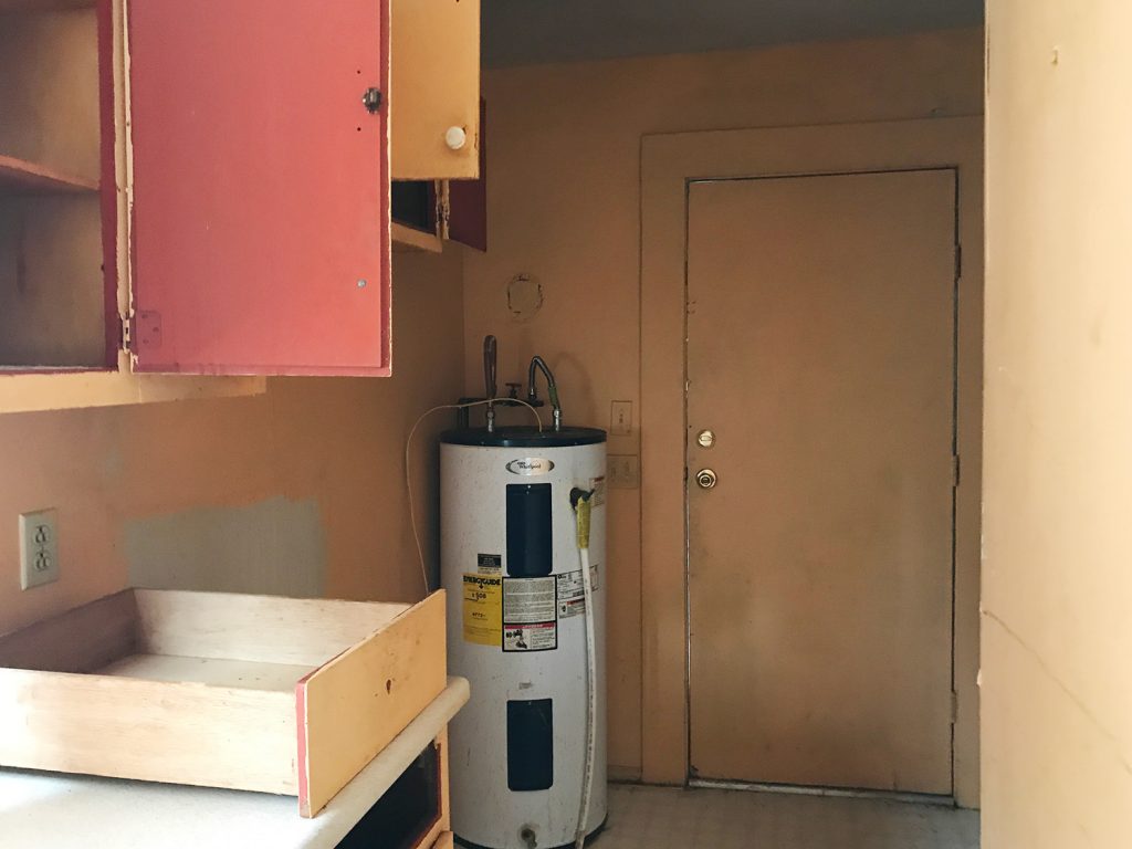 Before Of Mudroom Hallway With Water Heater And Orange Walls