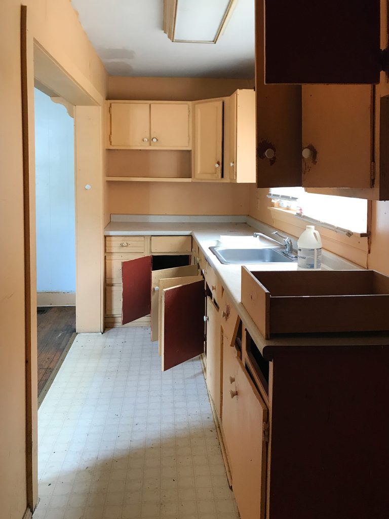 Before Photo Of Galley Style Kitchen With Orange Cabinets Open Into Corner