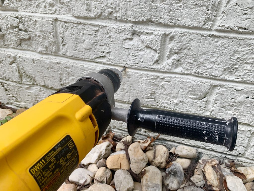 Hammer Drilling Making Hole In Brick Wall