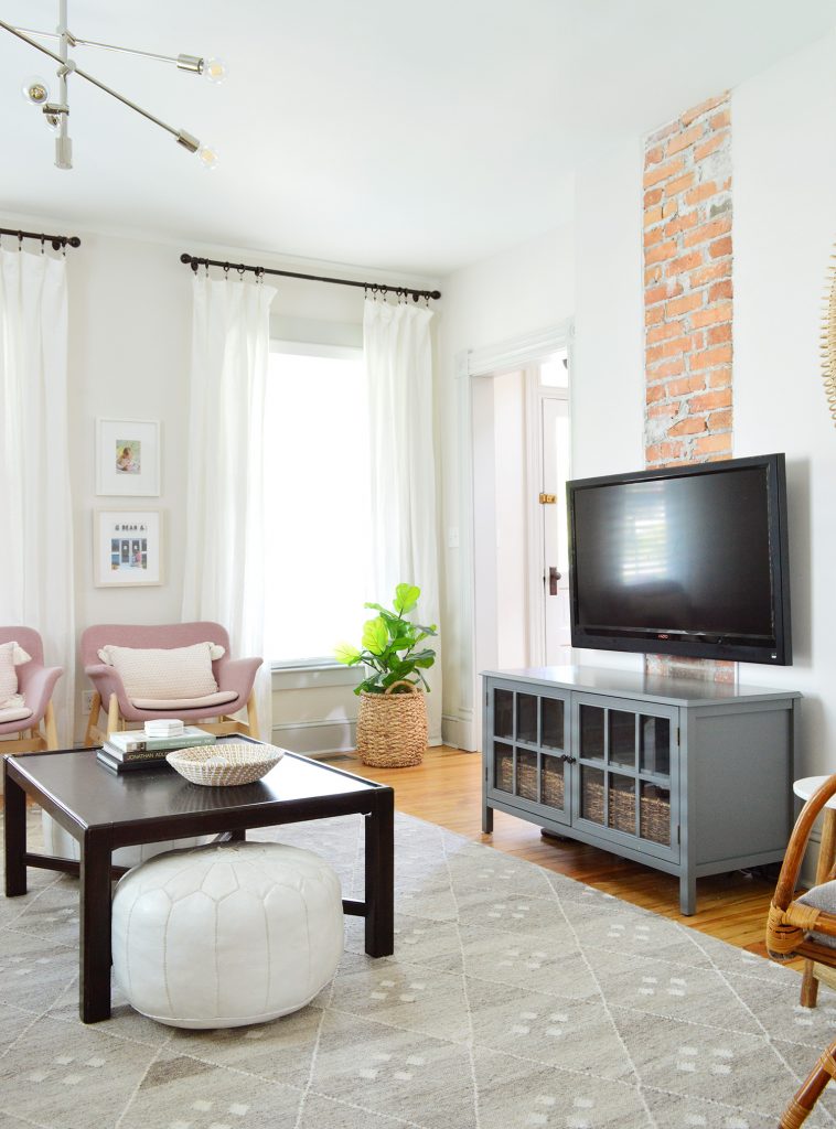 TV On Fireplace Wall With Gray Media Cabinet In Beach House Living Room