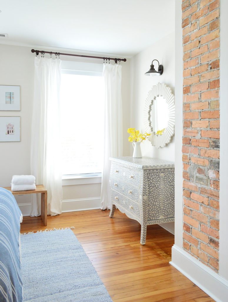 Exposed Brick Fireplace In Beach House Front Bedroom And Inlay Dresser
