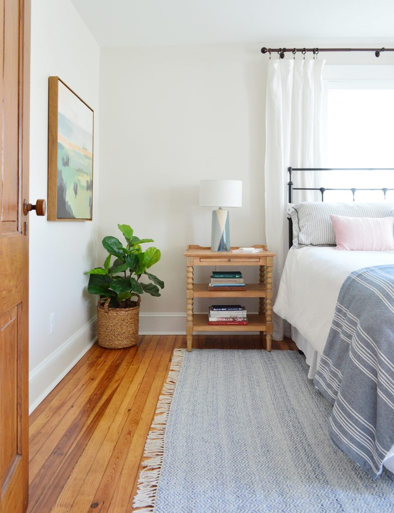 Beach House Front Bedroom With Blue Rug And Wooden Nightstand