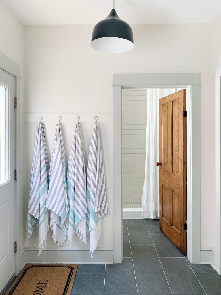 After View Towards Downstairs Bathroom With Reclaimed Wood Door And Towel Hooks And Slate Floor