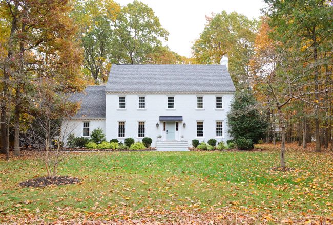 After Photo Of Traditional Colonial Brick Home With Moderne White Romabio Paint During Fall Season