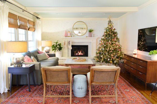 After Photo Of Living Room With White Walls And Colorful Traditional Rug And Holiday Christmas Tree