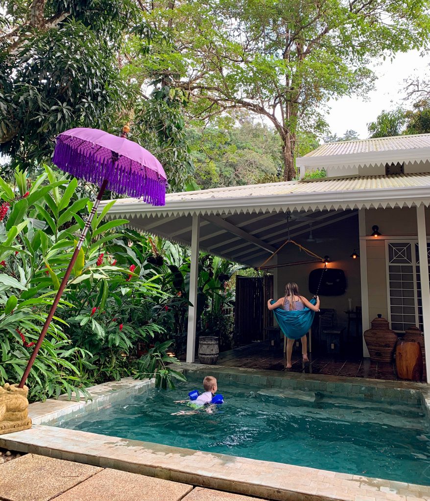 Kids Playing At Tropical Airbnb In Costa Rica With Pool And Swing