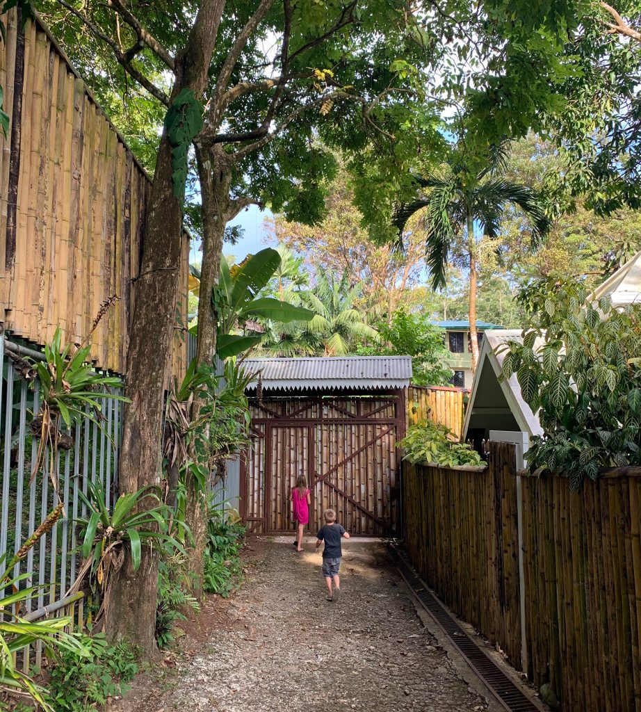 Young Kids Running Amongst Bamboo Fence In Costa Rica Airbnb